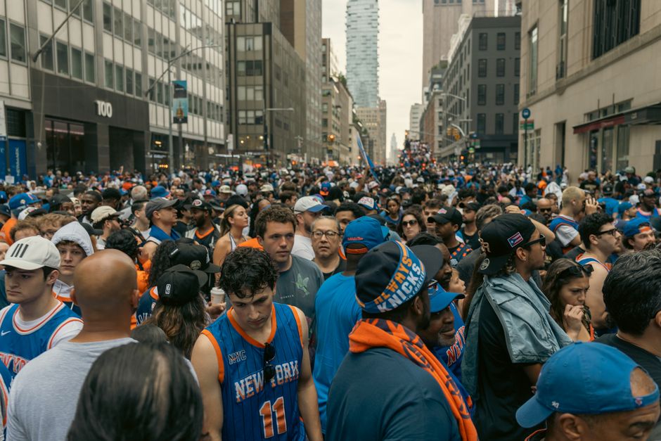 Thriving street celebration with a diverse crowd in New York, showcasing excitement and unity.
